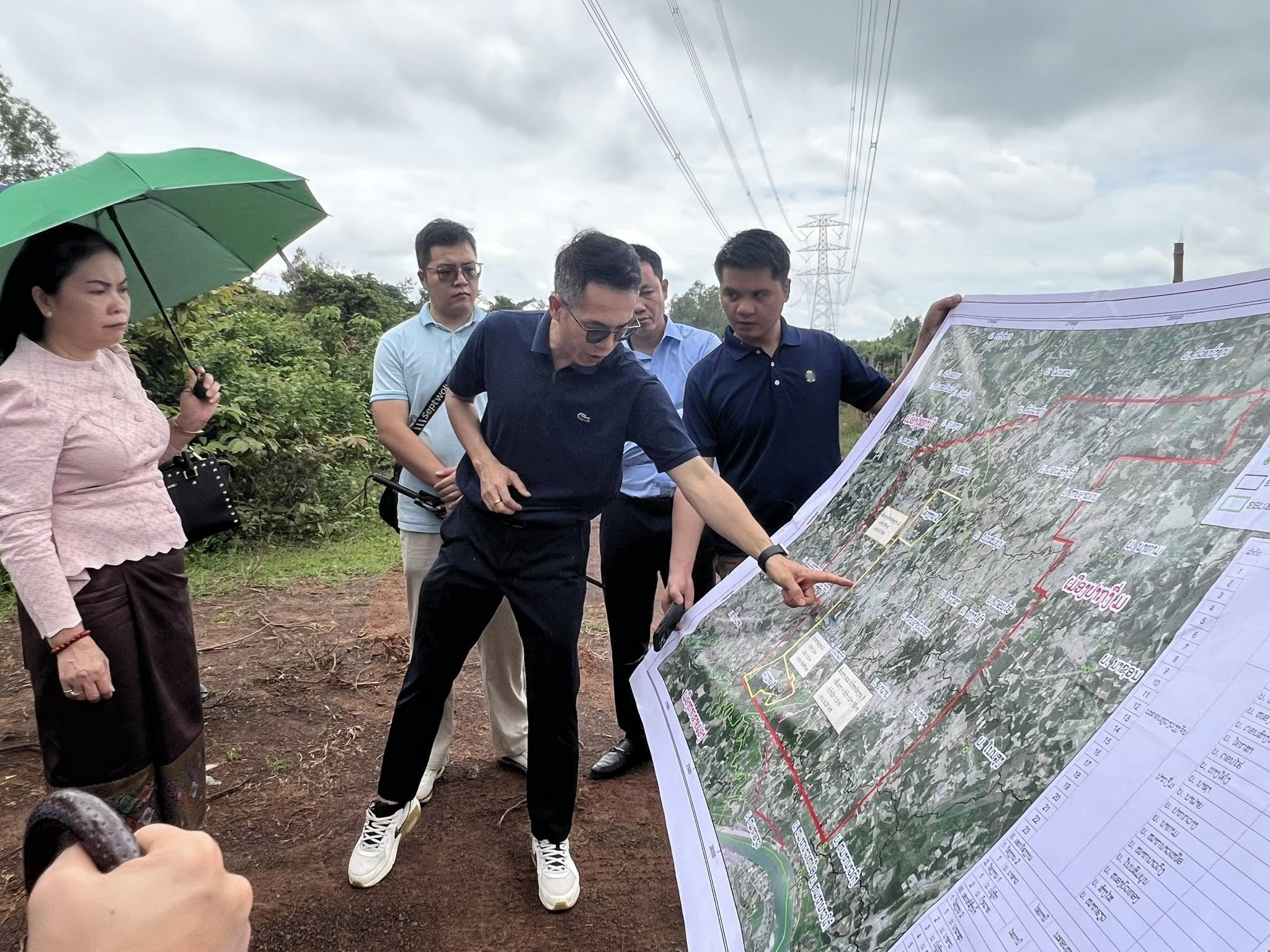 Team examining project route maps during field survey